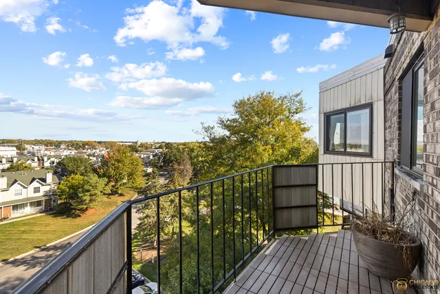 a view of a balcony with wooden floor and city view