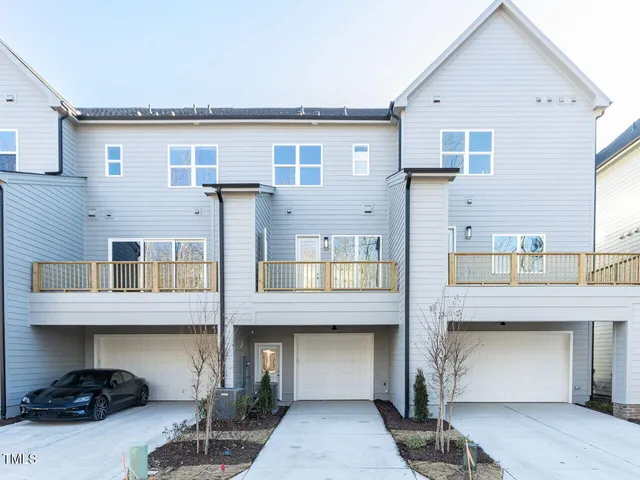 a living room with furniture and a kitchen view