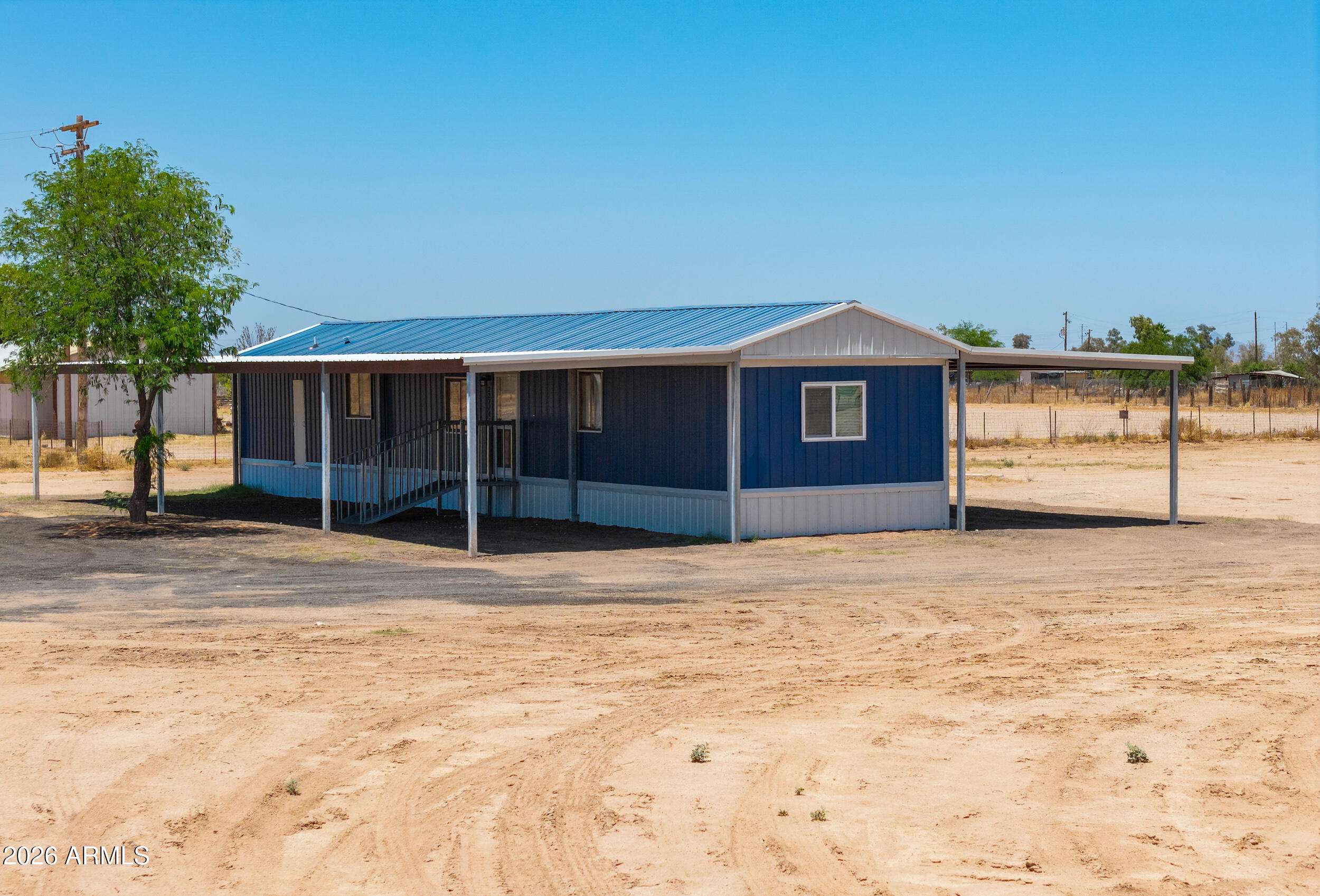 33776 West Siesta Road Stanfield, AZ 85172 - Photo 20 of 54 a front view of a house with a yard