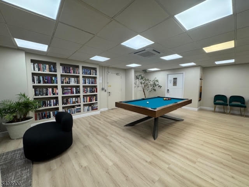 1203 River Road, Unit 19K Edgewater, NJ 07020 - Photo 13 of 19 a living room with furniture and a book shelf