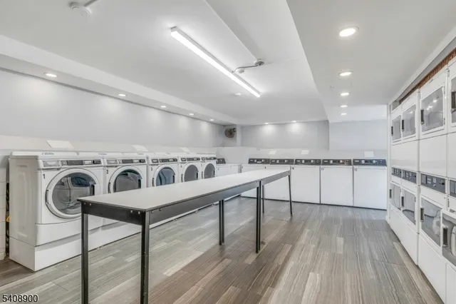 a view of a kitchen with furniture and wooden floor
