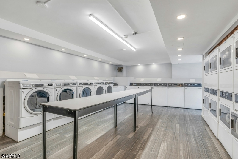 1203 River Road, Unit 19K Edgewater, NJ 07020 - Photo 15 of 19 a view of a kitchen with furniture and wooden floor