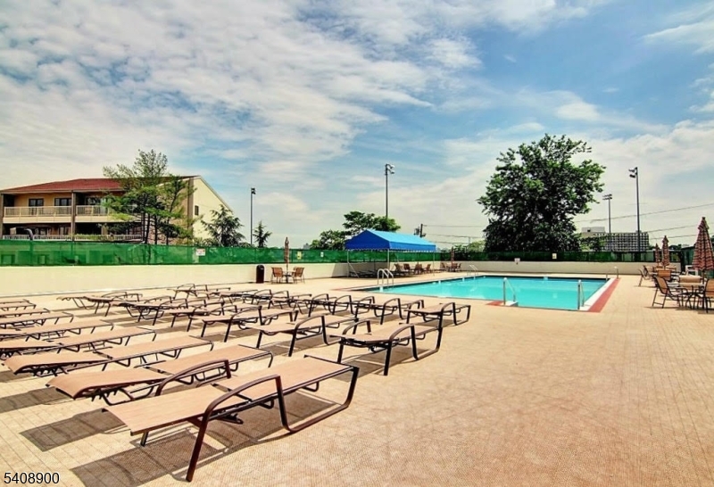 1203 River Road, Unit 19K Edgewater, NJ 07020 - Photo 17 of 19 a view of swimming pool with outdoor seating and yard in back