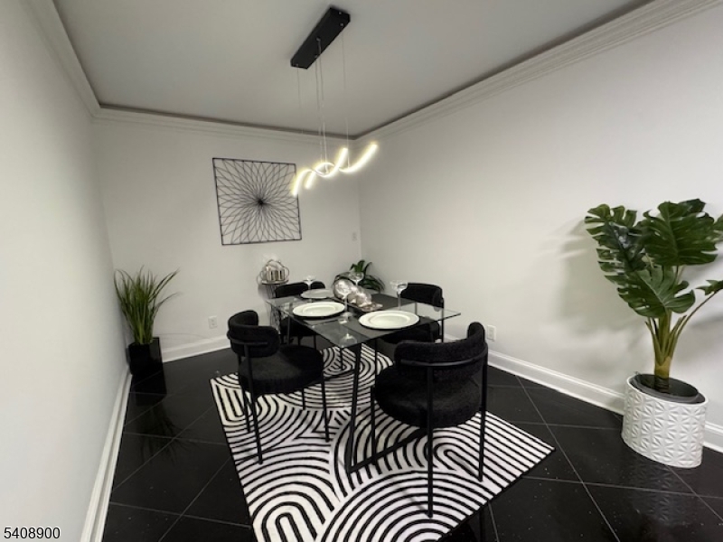 1203 River Road, Unit 19K Edgewater, NJ 07020 - Photo 5 of 19 a living room with furniture and a potted plant