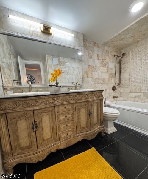 1203 River Road, Unit 19K Edgewater, NJ 07020 - Photo 9 of 19 a bathroom with a sink a toilet and mirror