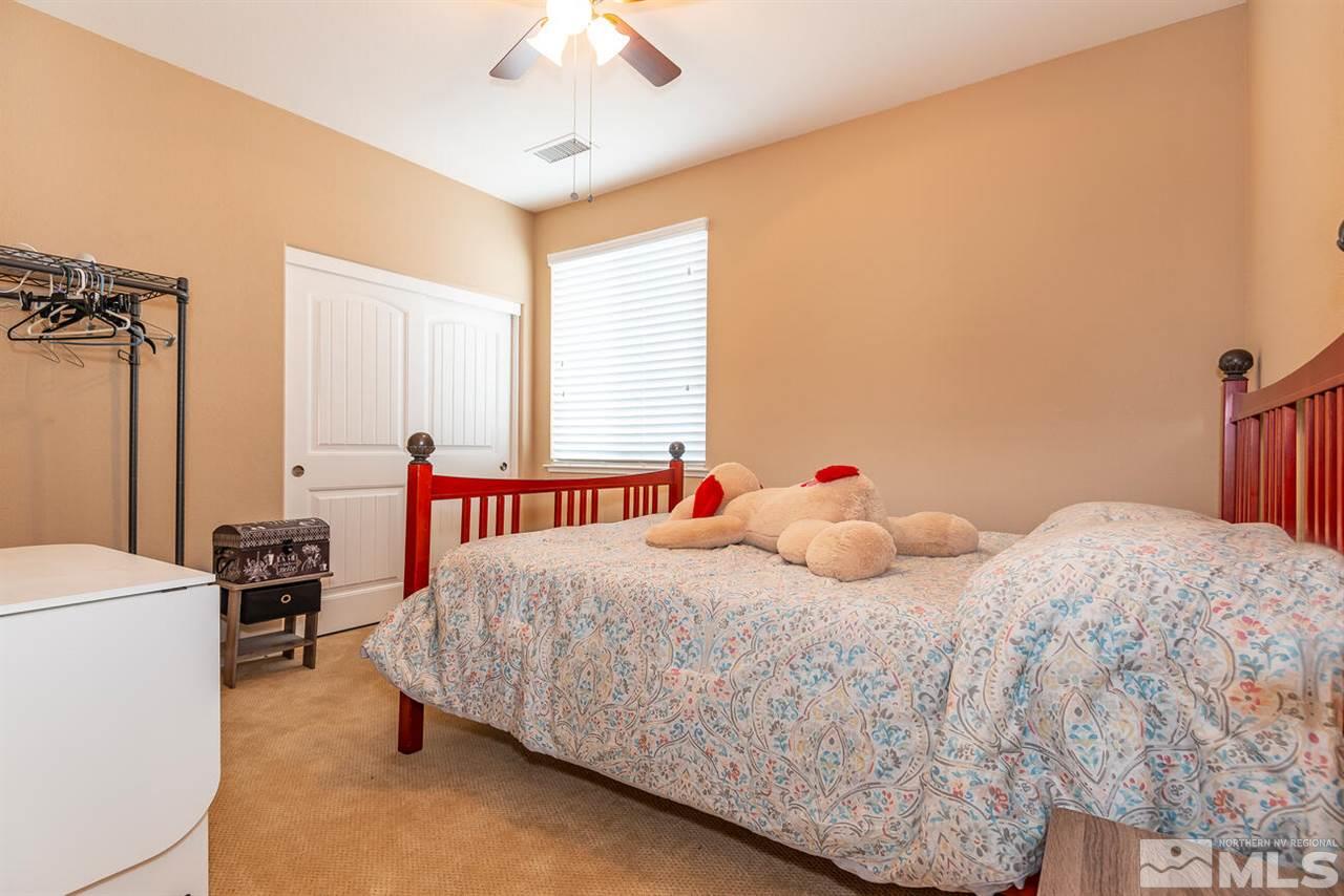 2065 Bears Ranch Drive Reno, NV 89521 - Photo 12 of 20 a bedroom with a bed and a chandelier