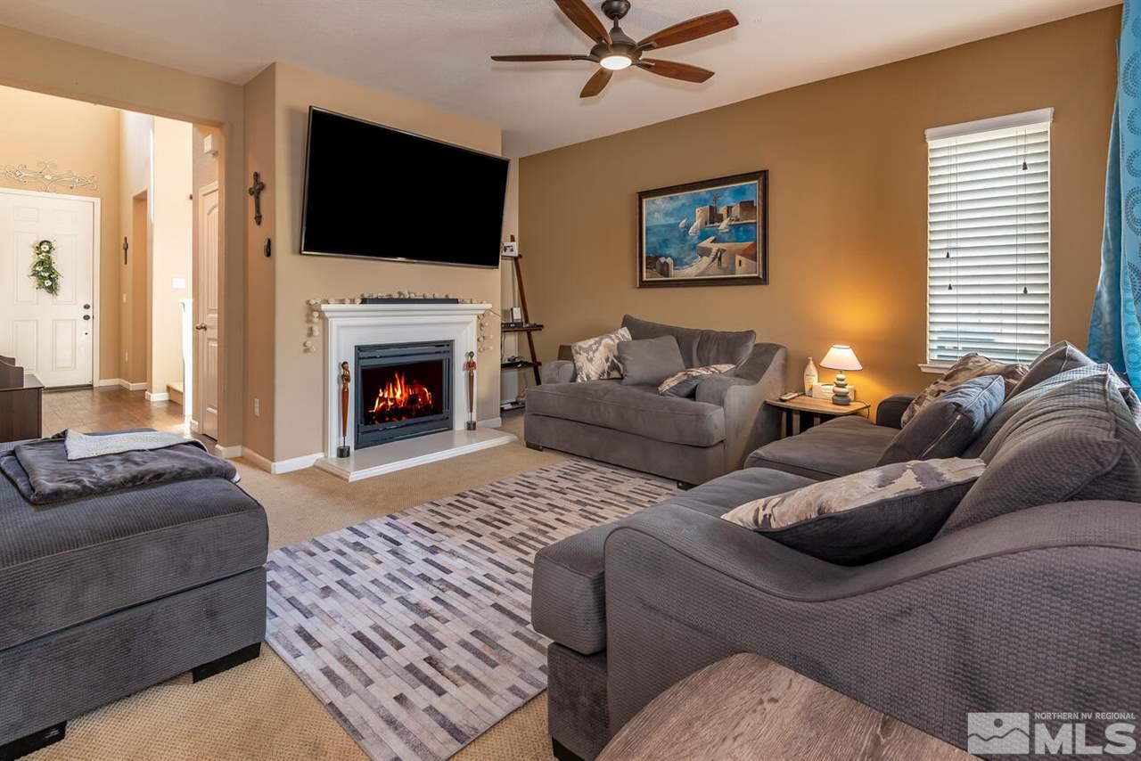 2065 Bears Ranch Drive Reno, NV 89521 - Photo 3 of 20 a living room with furniture a flat screen tv and a fireplace