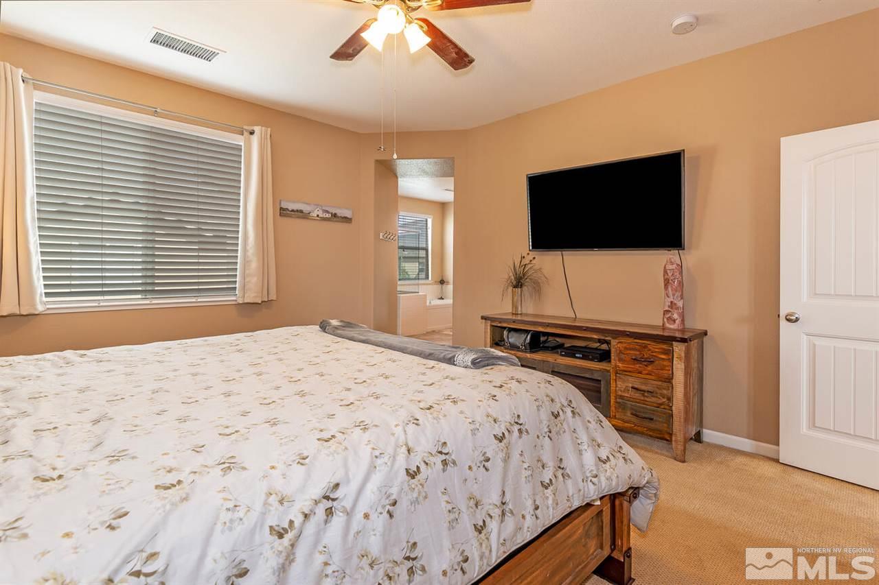 2065 Bears Ranch Drive Reno, NV 89521 - Photo 9 of 20 a bedroom with a bed and a flat screen tv