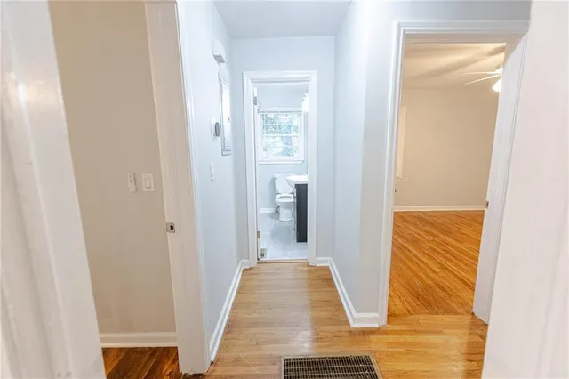 a view of hallway with wooden floor