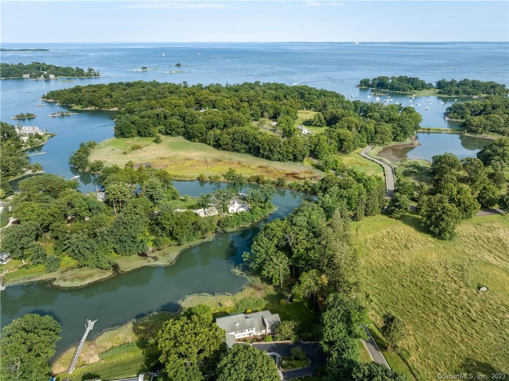 an aerial view of a houses with a lake