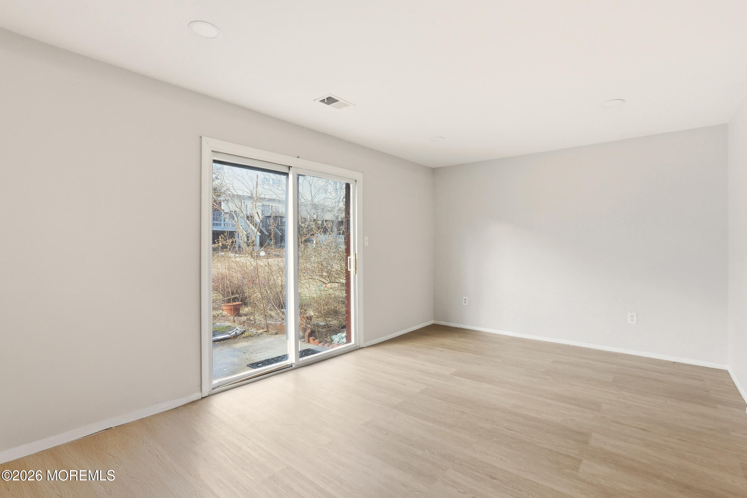 194 Sawmill Road, Unit 480 Brick, NJ 08724 - Photo 14 of 20 an empty room with wooden floor and windows