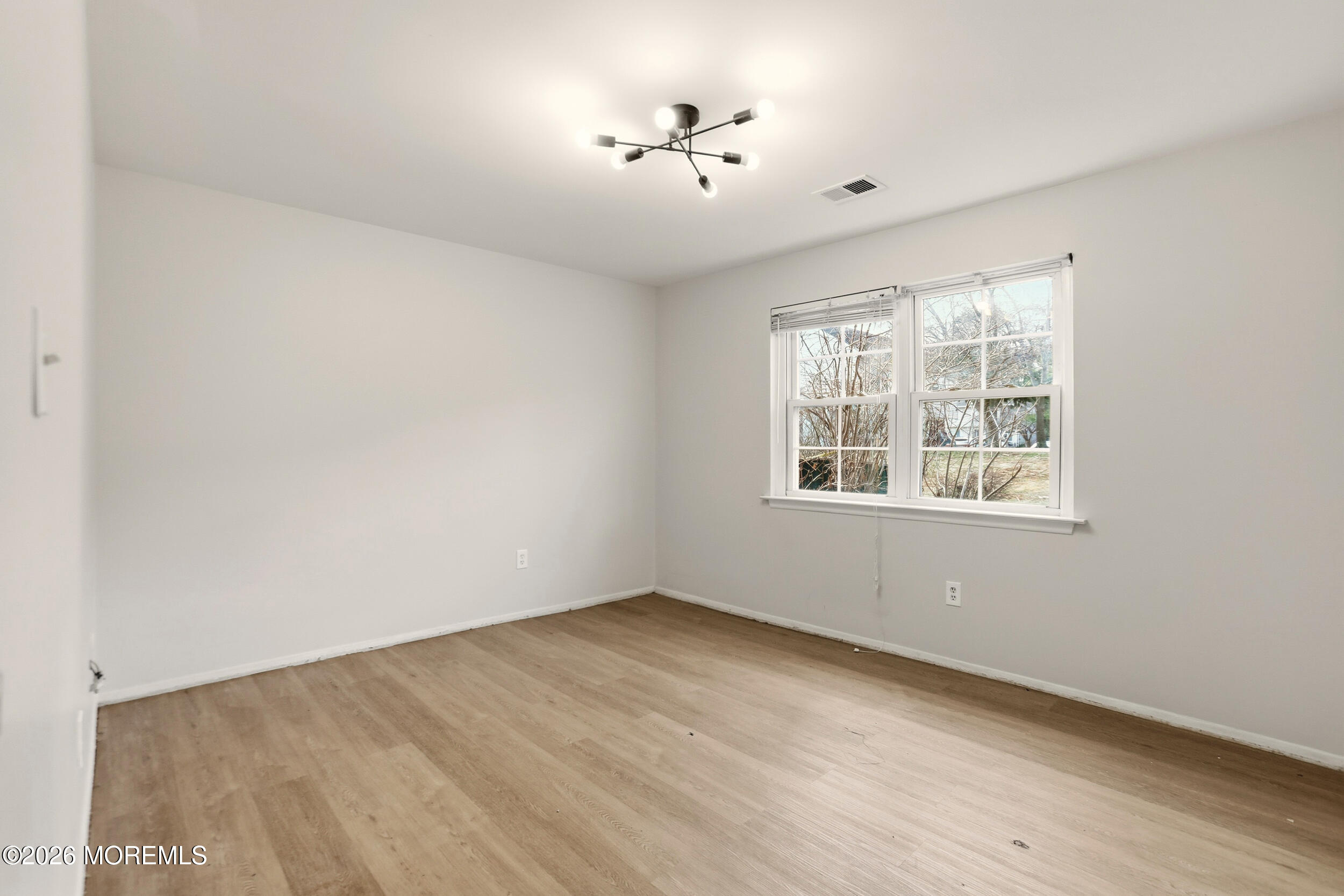 194 Sawmill Road, Unit 480 Brick, NJ 08724 - Photo 10 of 20 wooden floor in an empty room with a window