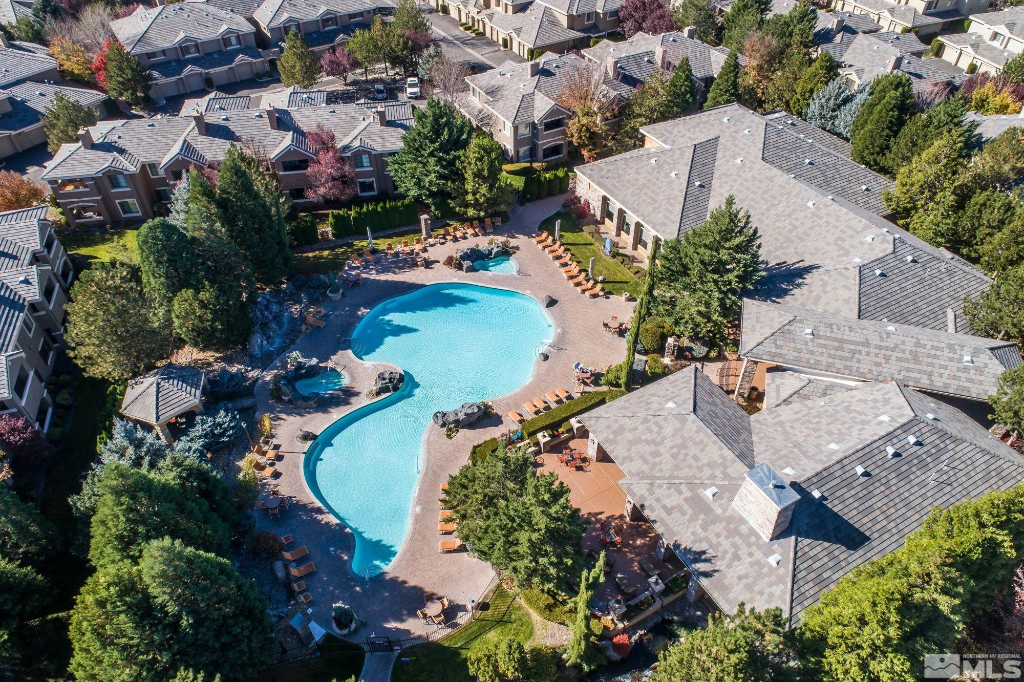 an aerial view of a house with a swimming pool