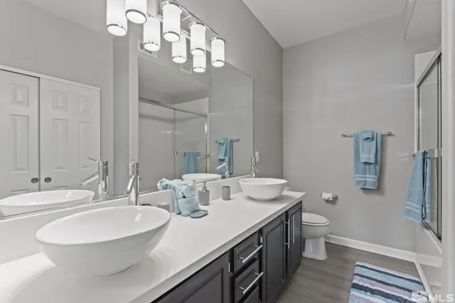 a bathroom with a double vanity sink and a mirror