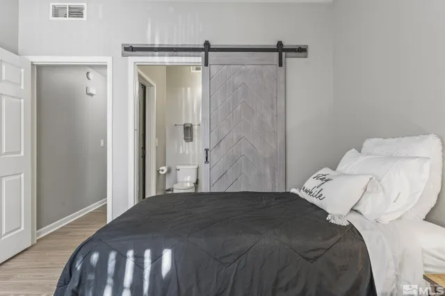 a bedroom with a bed and a mirror