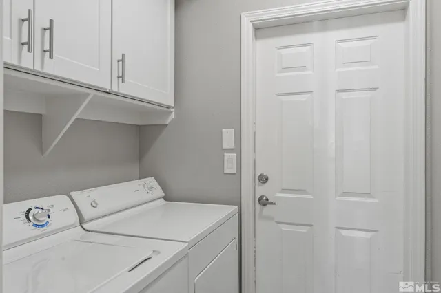 a view of a livingroom with wooden cabinets and a ceiling fan
