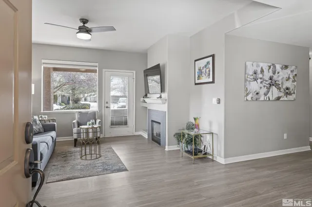 a view of a livingroom with furniture window and wooden floor