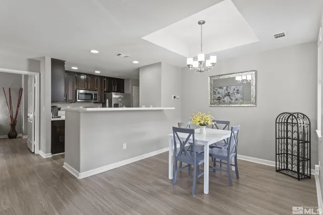 a view of a dining room with furniture and wooden floor