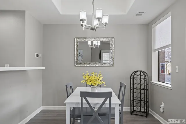 a view of a dining room with furniture and chandelier