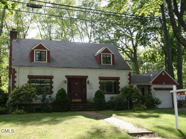 514 Davis Road Fairfield, CT 06825 - Photo 1 of 1 a front view of a house with a yard and garage