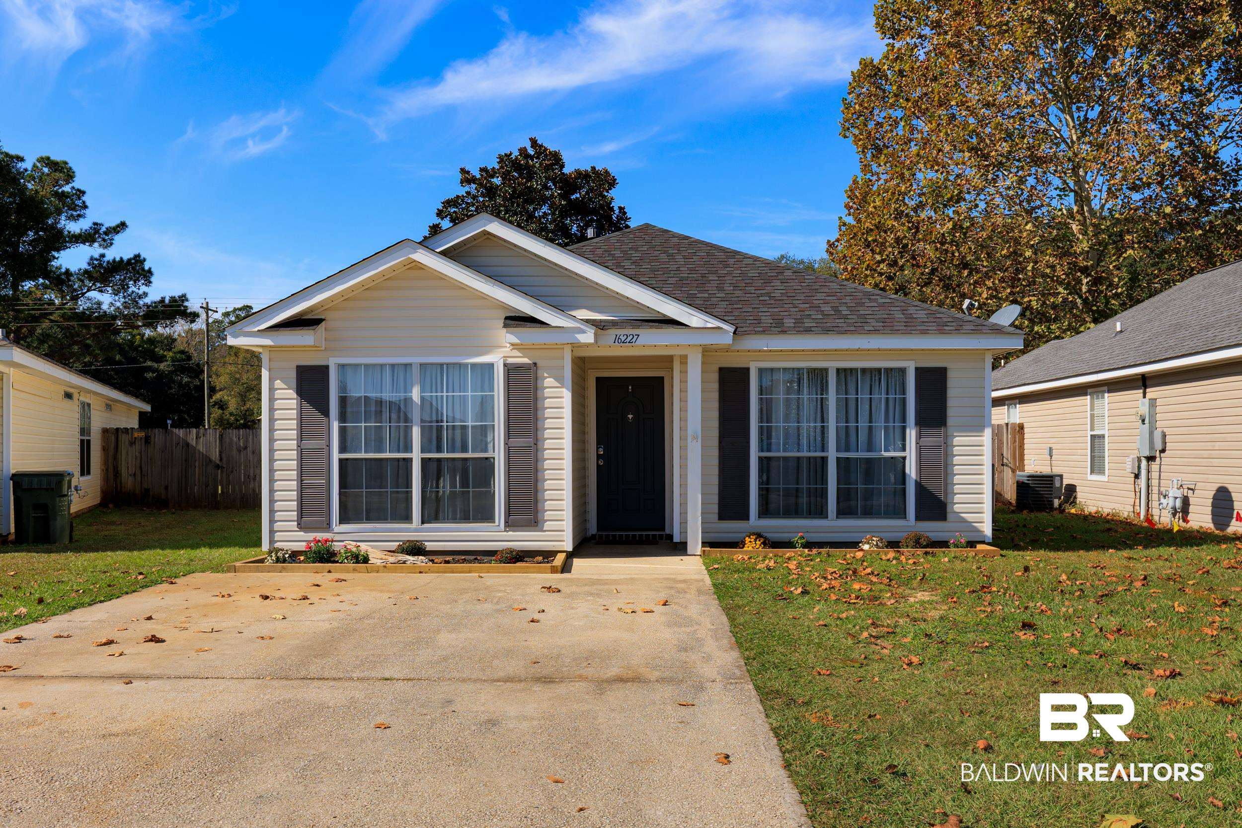 View of front of home with a shingled roof