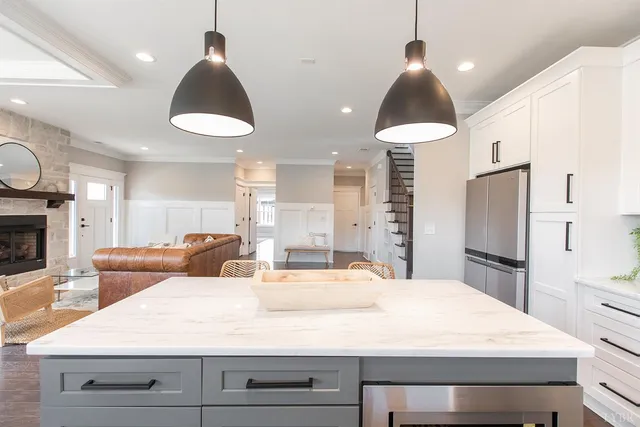 a white toilet sitting next to a white sink and vanity