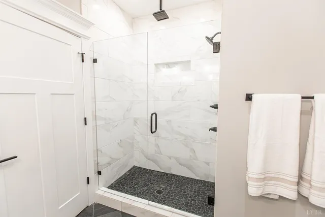 a bathroom with a toilet and a shower