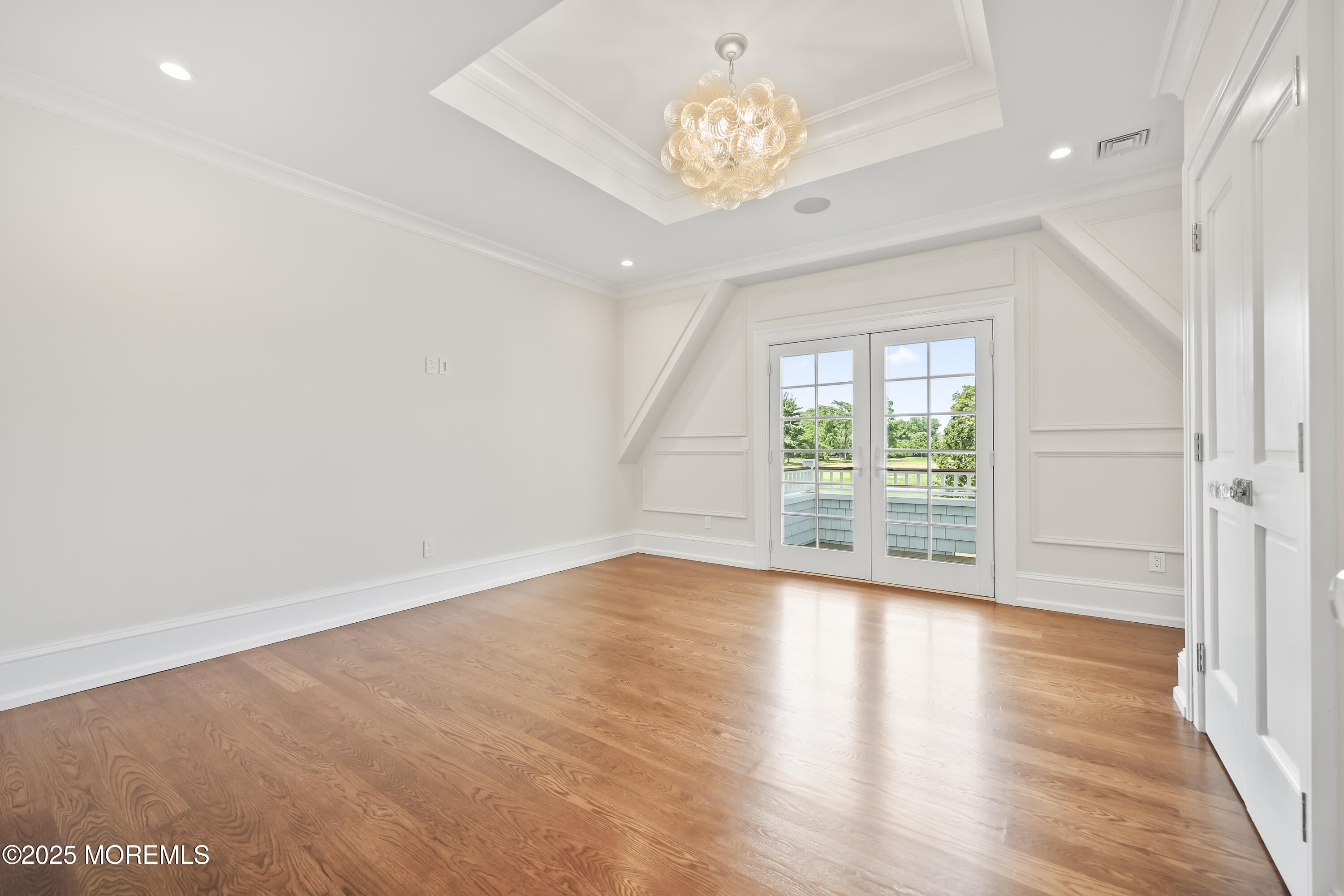 4 Club Way Rumson, NJ 07760 - Photo 22 of 79 an empty room with wooden floor and large window