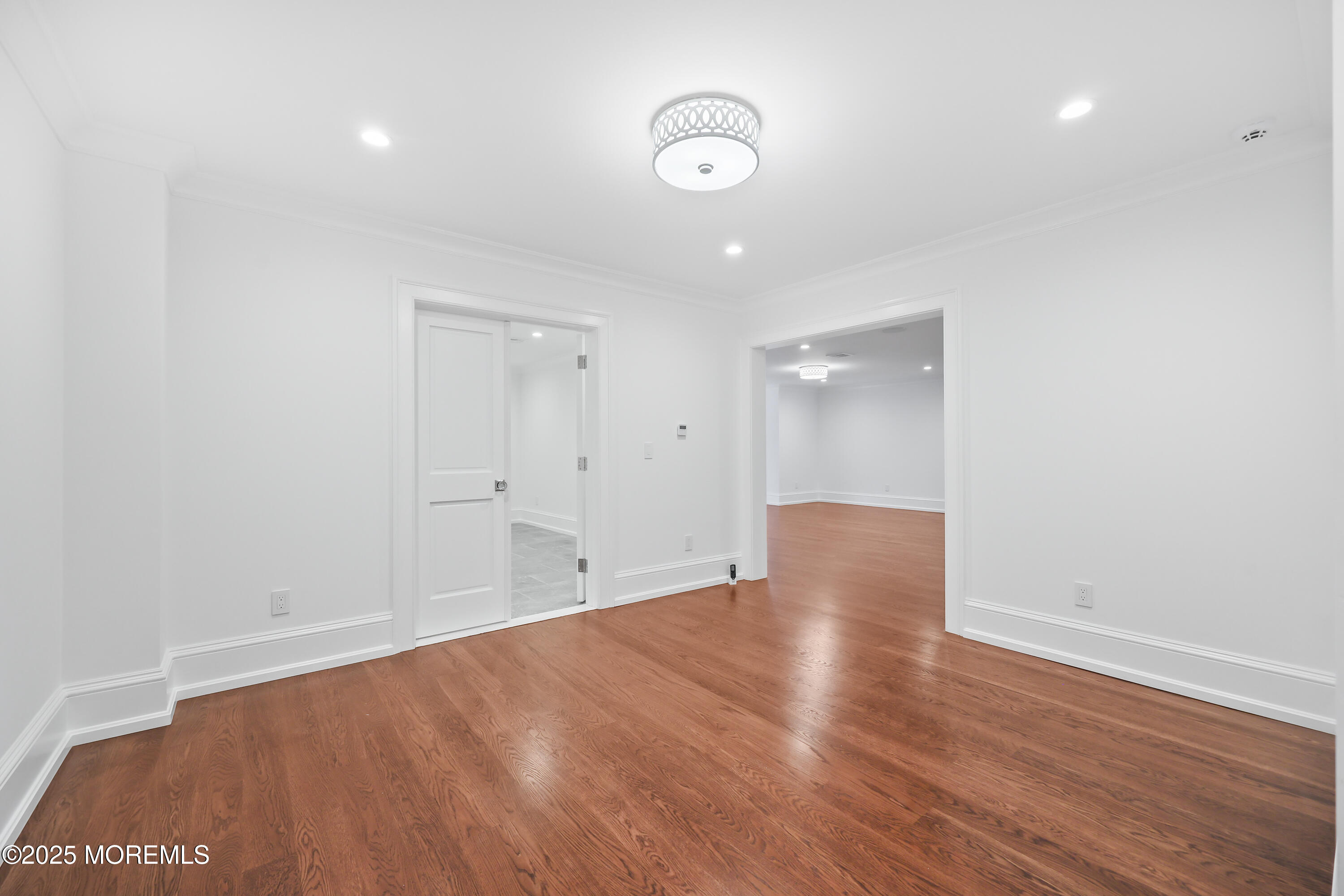 4 Club Way Rumson, NJ 07760 - Photo 23 of 79 a view of an empty room with wooden floor and a window