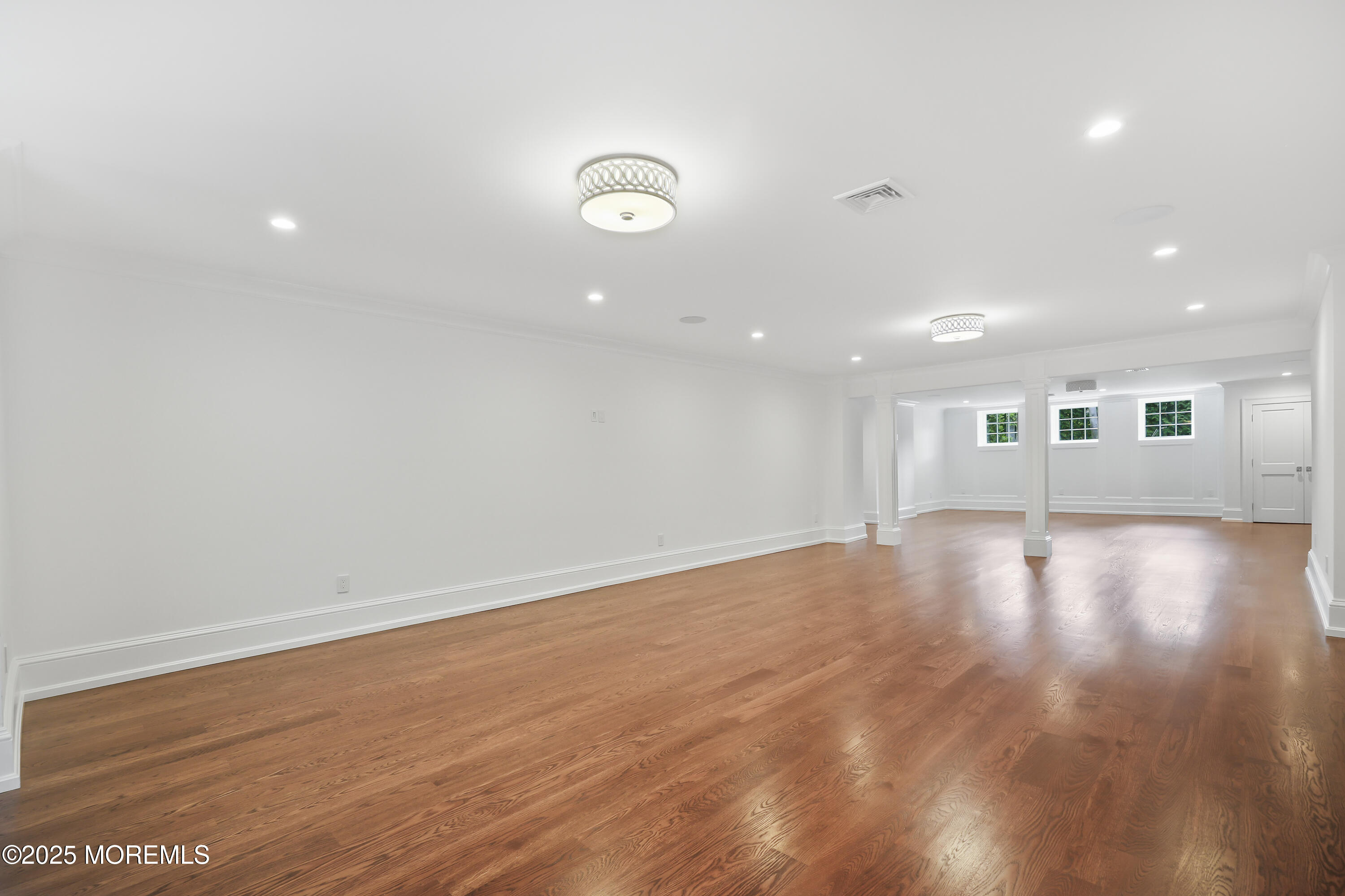 4 Club Way Rumson, NJ 07760 - Photo 27 of 79 an empty room with wooden floor and windows