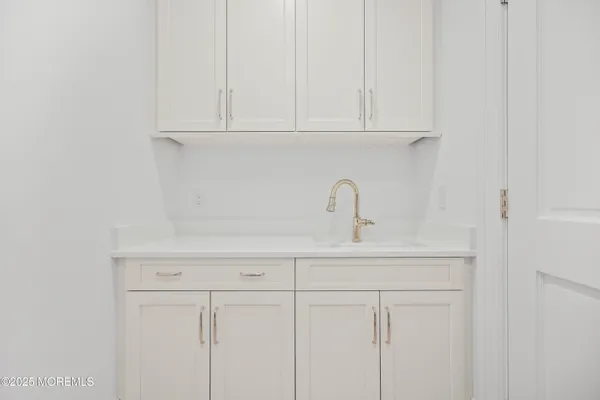 an empty room with wooden floor fireplace and windows