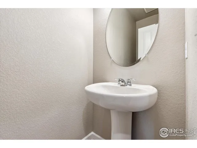 a bathroom with a sink a mirror and a vanity