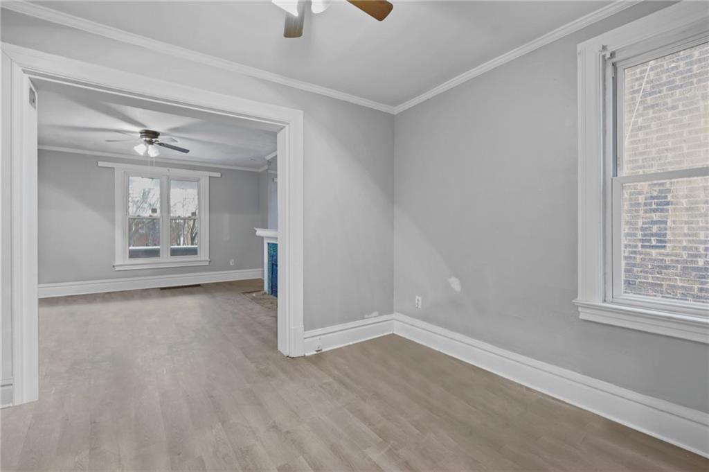 1210 Maple Avenue, Unit 1 Turtle Creek, PA 15145 - Photo 3 of 5 a view of an empty room with a window and wooden floor