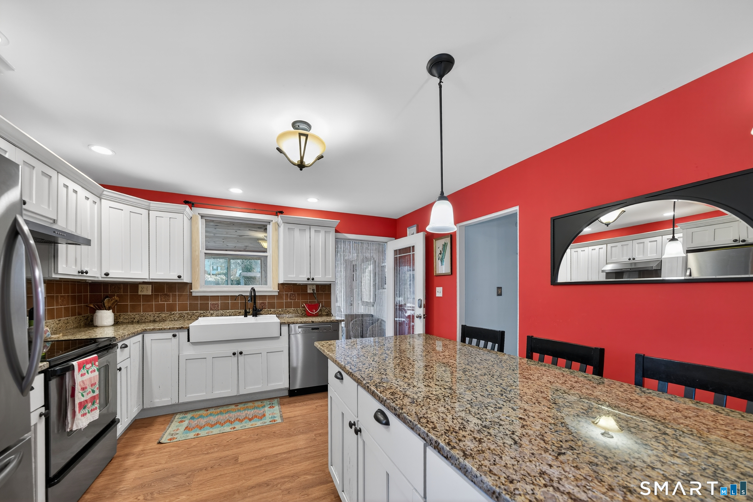 80 Santa Fe Avenue Hamden, CT 06517 - Photo 14 of 28 a kitchen with stainless steel appliances kitchen island granite countertop a stove a sink and a microwave