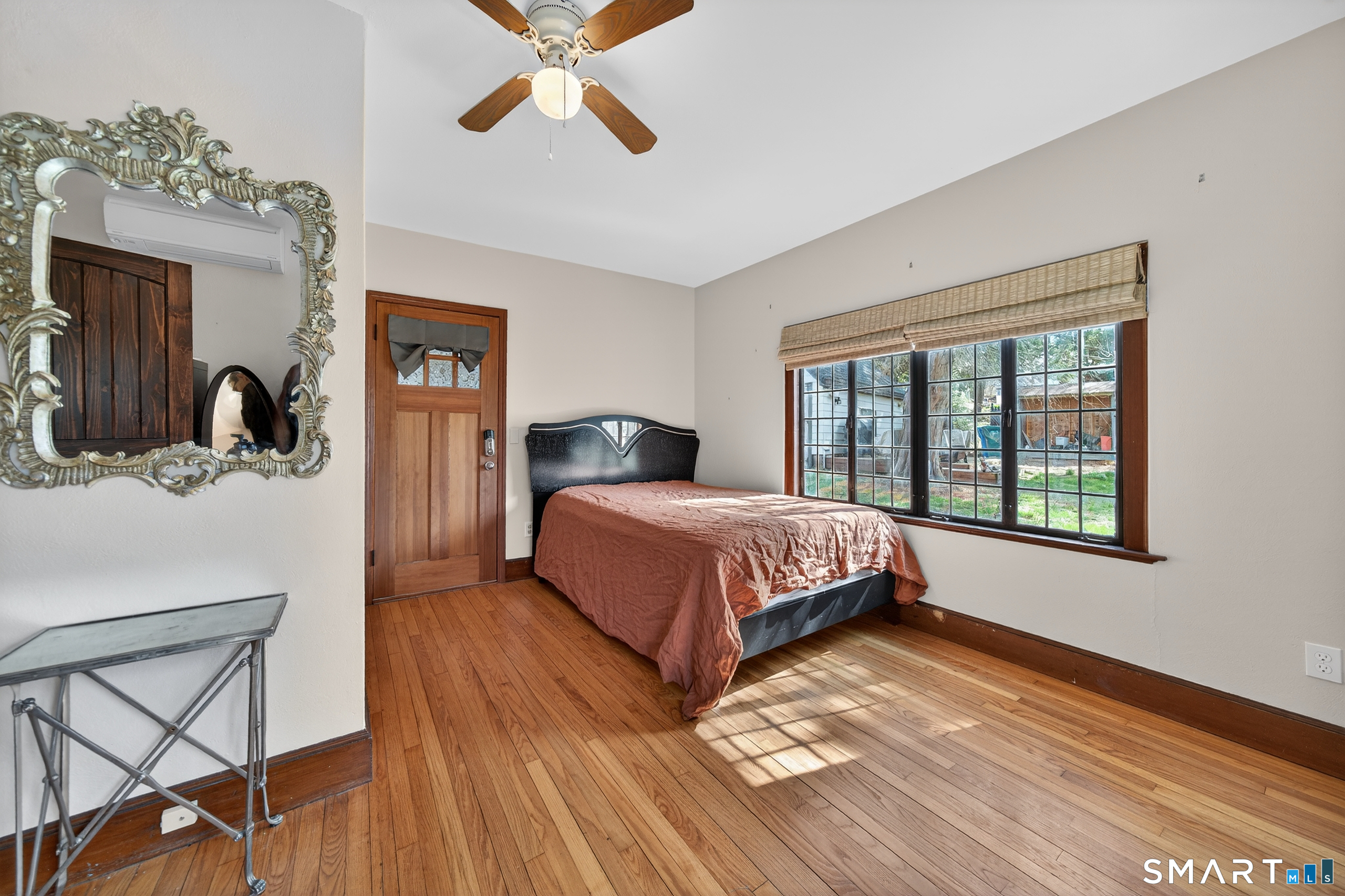 80 Santa Fe Avenue Hamden, CT 06517 - Photo 18 of 28 a bedroom with a large bed and a chandelier