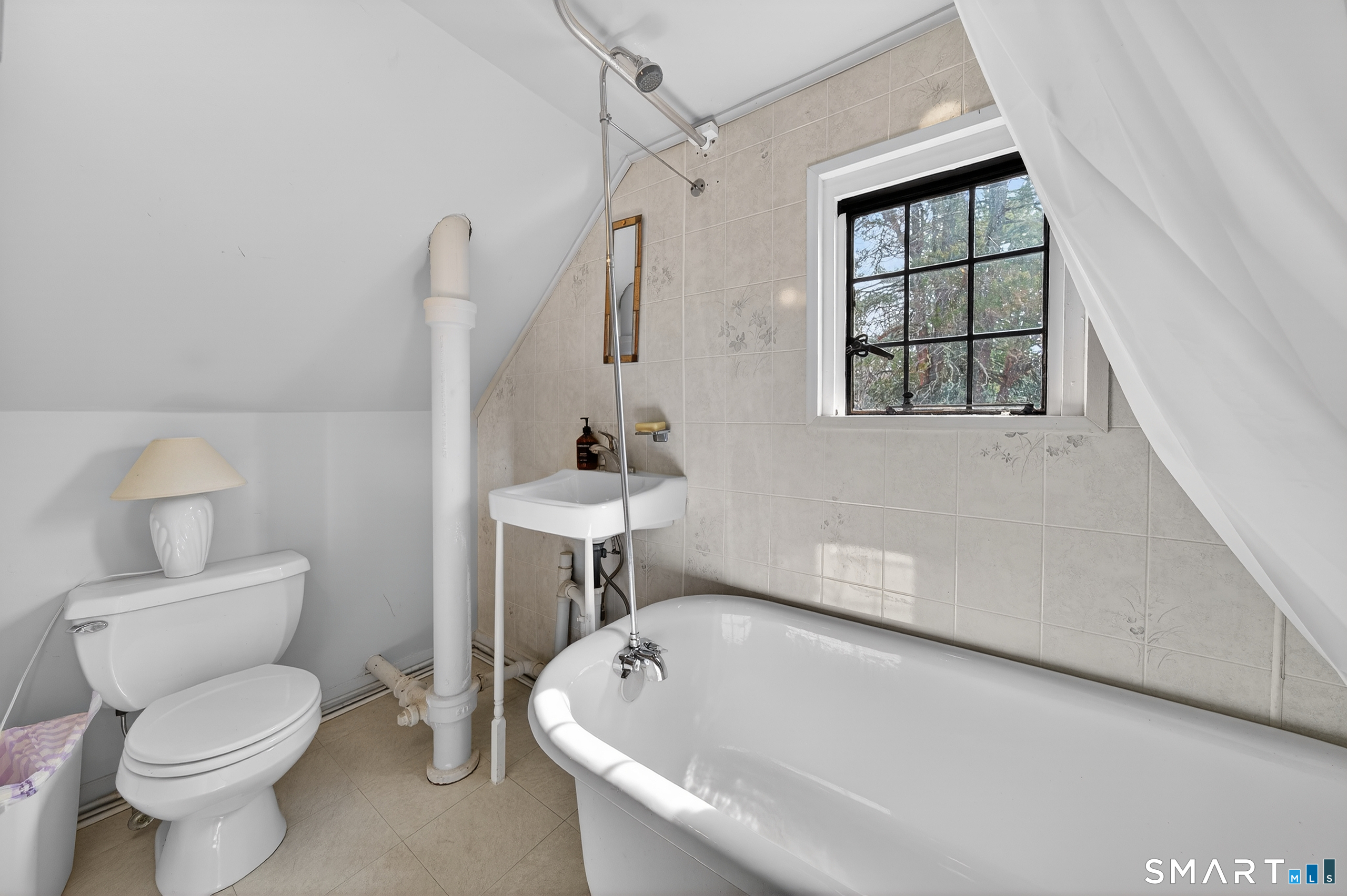 80 Santa Fe Avenue Hamden, CT 06517 - Photo 26 of 28 a white toilet sitting next to a bathroom sink and tub