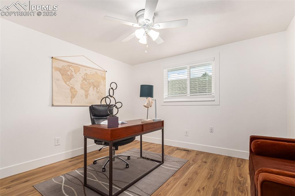 737 Utica Street Denver, CO 80204 - Photo 11 of 41 a workspace with furniture and wooden floor