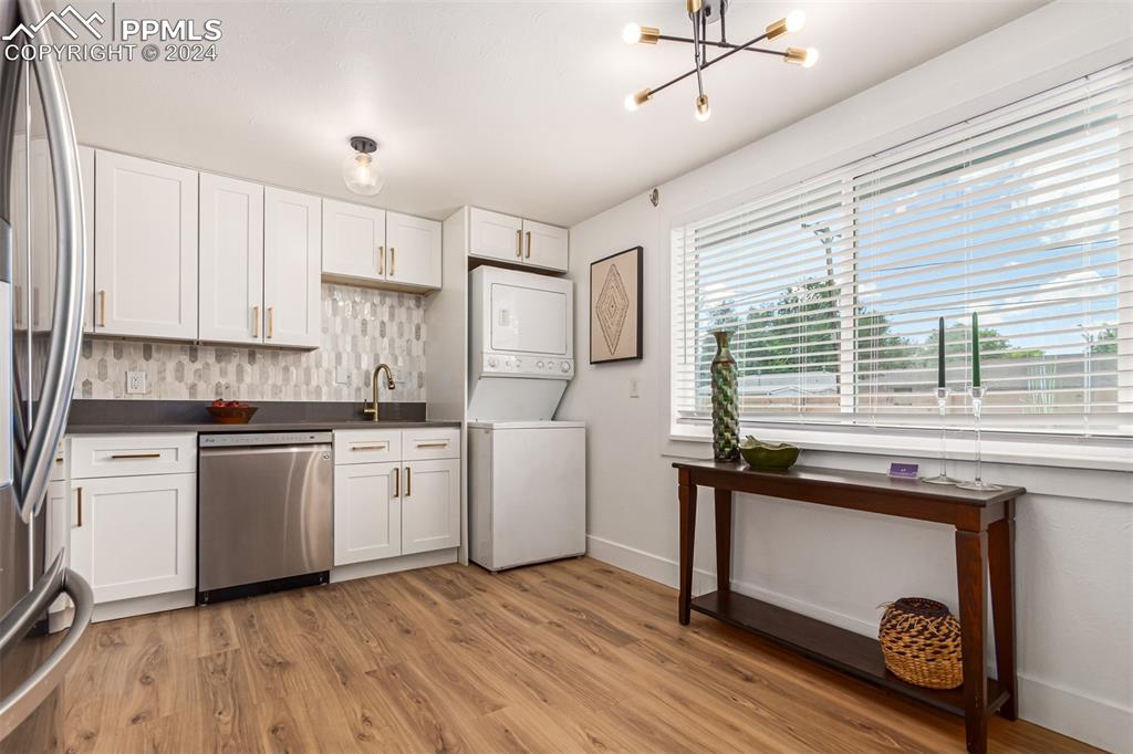 737 Utica Street Denver, CO 80204 - Photo 13 of 41 a kitchen with a sink appliances cabinets and a window
