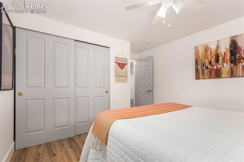 737 Utica Street Denver, CO 80204 - Photo 21 of 41 a bedroom with a large bed and a chandelier
