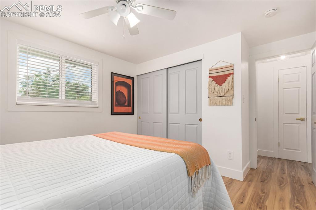 737 Utica Street Denver, CO 80204 - Photo 22 of 41 a bedroom with a large bed and a chandelier