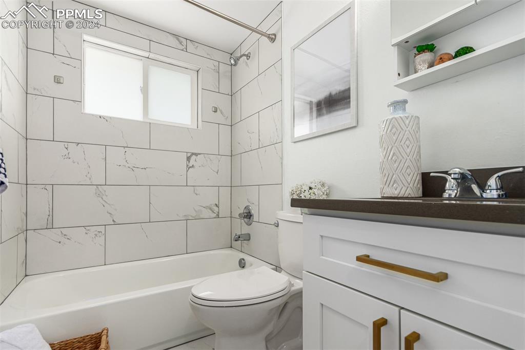 737 Utica Street Denver, CO 80204 - Photo 23 of 41 a bathroom with a sink a toilet and shower