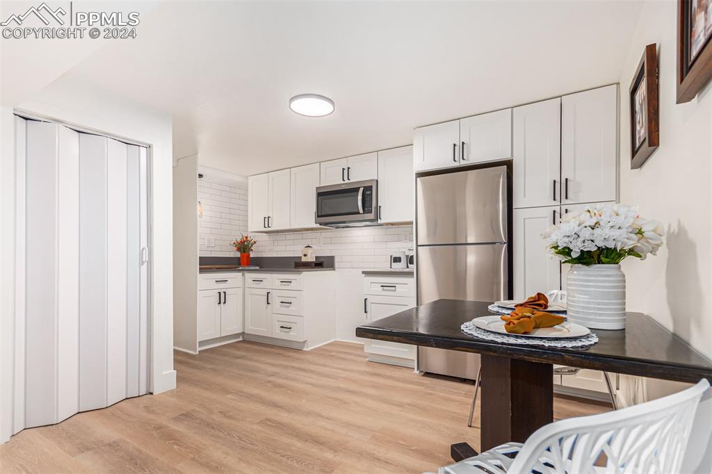 737 Utica Street Denver, CO 80204 - Photo 33 of 41 a kitchen with stainless steel appliances refrigerator stove microwave and refrigerator