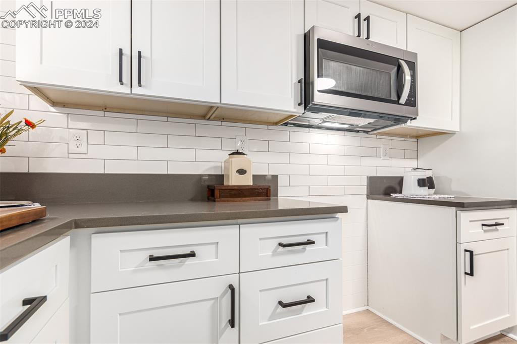737 Utica Street Denver, CO 80204 - Photo 35 of 41 a kitchen with appliances cabinets and a microwave oven