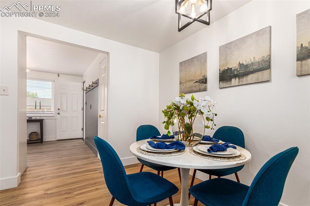 737 Utica Street Denver, CO 80204 - Photo 10 of 41 a view of a dining room with furniture and wooden floor