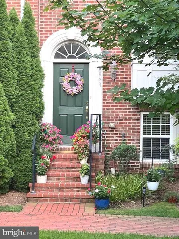 a view of front door of house with potted plant