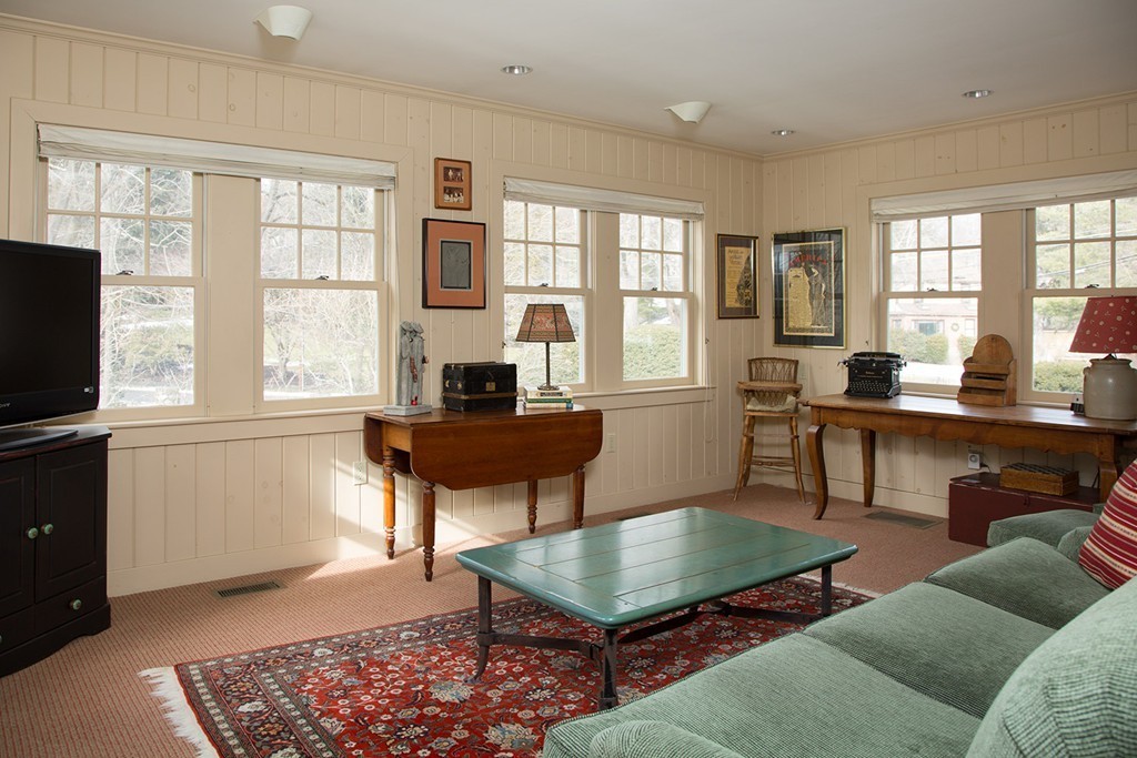 59 Tamworth Road Newton, MA 02468 - Photo 7 of 11 a living room with furniture a flat screen tv and a large window