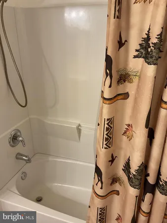 a bedroom with a bed and a flat tv screen on a dresser