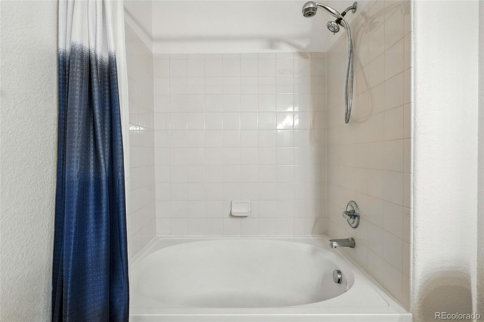 7080 Simms Street, Unit 204 Arvada, CO 80004 - Photo 26 of 49 a bathroom with a bathtub