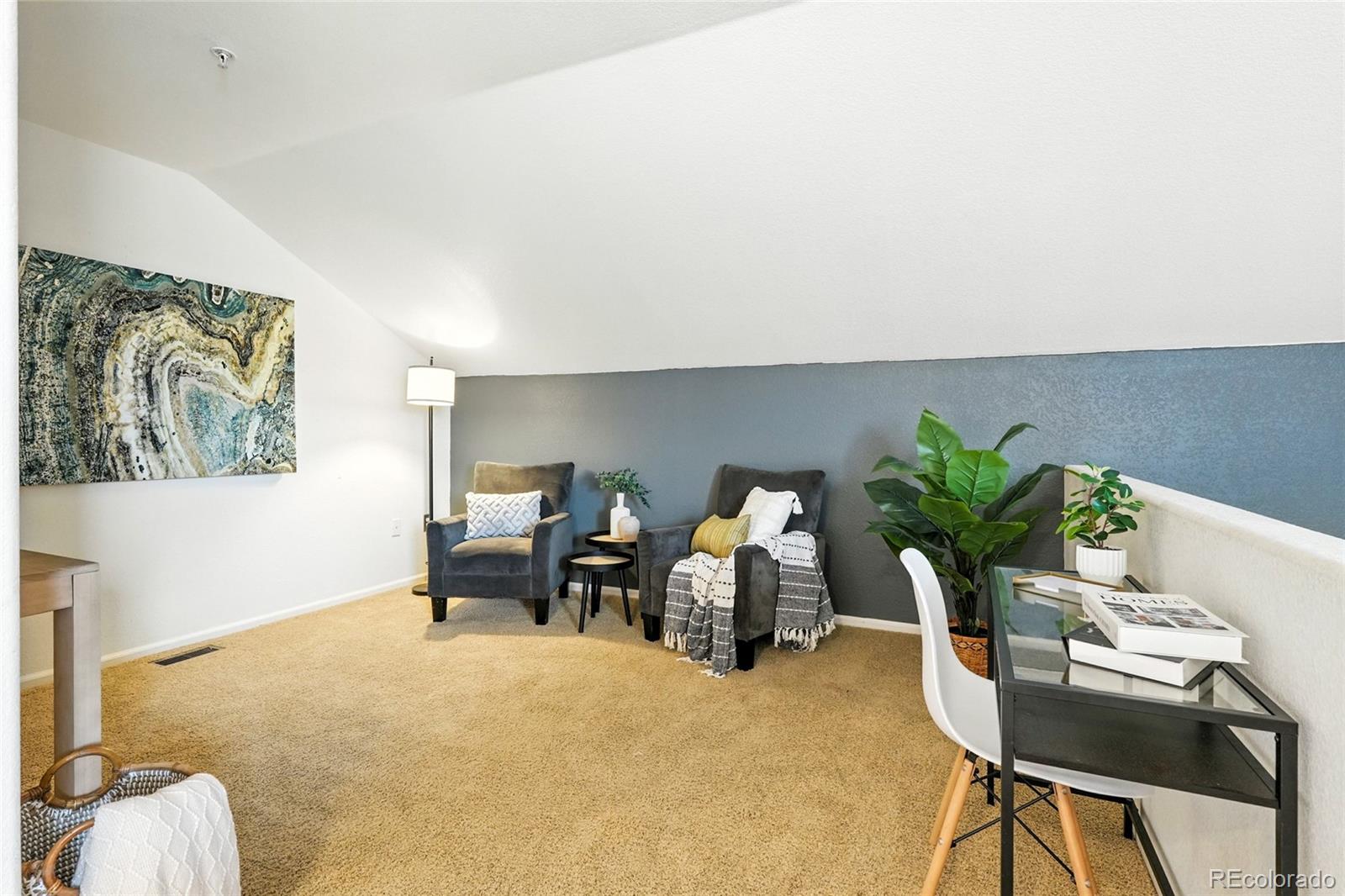 7080 Simms Street, Unit 204 Arvada, CO 80004 - Photo 29 of 49 a living room with furniture flowerpot and a potted plant