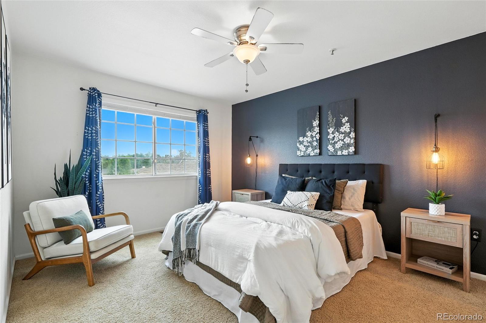 7080 Simms Street, Unit 204 Arvada, CO 80004 - Photo 34 of 49 a bedroom with a bed and a chandelier